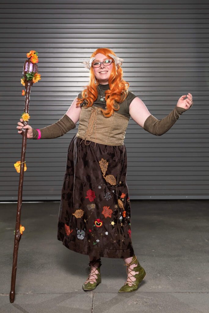 Molly in their Keyleth Cosplay photographed against a grey background.